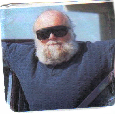 1987 Ford Crown Victoria LTD - Man with beard and sunglasses inside a vehicle.