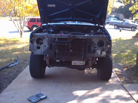 1990 Ford Bronco - This Ford truck is undergoing front-end repairs, with its hood and grille removed.