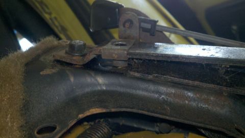 1978 Ford Bronco - Detail of a vehicle's seat adjustment mechanism, showing wear and rust.