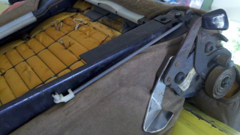 1978 Ford Bronco - Close-up of a seat adjustment mechanism, showing the internal workings and a small label.