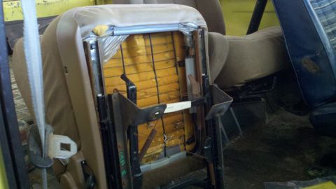 1978 Ford Bronco - Interior view of a disassembled car seat, revealing its internal structure and worn upholstery.
