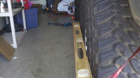 1978 Ford Bronco - A close-up view of a vehicle's tire, with a level tool positioned beside it.