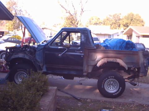 1990 Ford Bronco - This 1990 Ford Bronco is in a state of repair, with its engine out and bed covered.