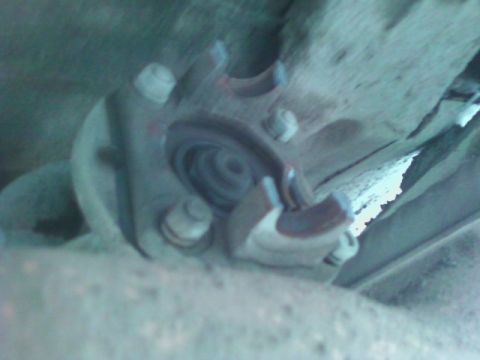 1990 Ford Bronco - Close-up of an unidentified vehicle suspension part, showing bolts and metalwork.