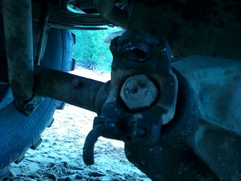1990 Ford Bronco - Undercarriage view of a vehicle's rear axle assembly, showing suspension components.