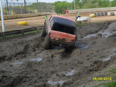 1978 Ford Bronco - This vehicle is navigating a challenging muddy course, with onlookers observing the difficult terrain.