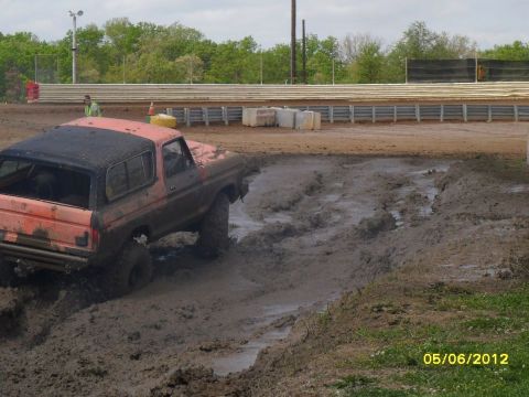 1978 Ford Bronco - A 1978 Ford Bronco navigates a muddy track during an event.