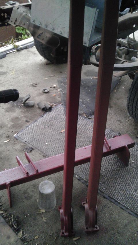 1987 Ford Ranger - The photo shows a vehicle frame and suspension parts, with some red painted metal pieces in the foreground.