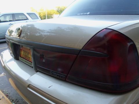 2000 Mercury Grand Marquis - The rear of a sedan is shown, with a license plate and a partial view of another vehicle in the background.