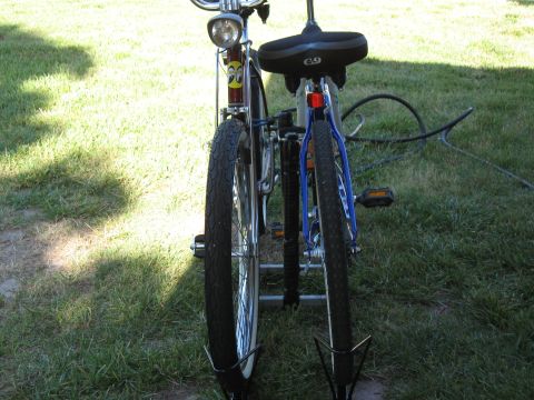 1994 Ford Bronco - Two bicycles are parked outdoors on a grassy area, viewed from behind.