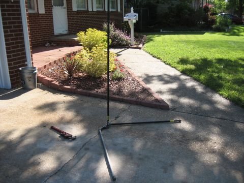 1994 Ford Bronco - A residential driveway with plumbing pipes and a wrench on the concrete.