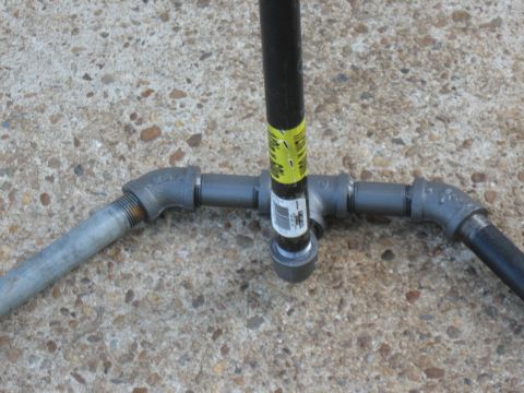1994 Ford Bronco - A close-up view of plumbing pipes and fittings, including a yellow label with some text.