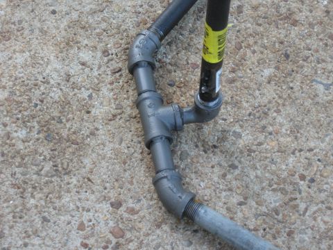 1994 Ford Bronco - Close-up of plumbing pipes and connectors on a concrete surface.