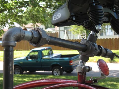 1994 Ford Bronco - A green pickup truck is visible in the background behind the frame of a bicycle.