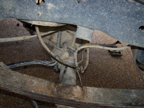 1992 Ford Bronco - Close-up view of the rear suspension system, showing the leaf springs and shock absorber.