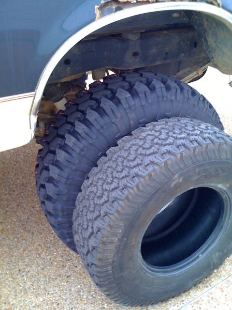 1992 Ford Bronco - Two large off-road tires are visible beneath the wheel well of a vehicle, suggesting a lift or tire upgrade.