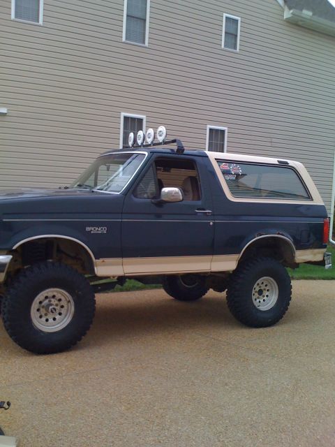 1992 Ford Bronco - Lifted 1992 Ford Bronco with off-road tires and roof-mounted lights.