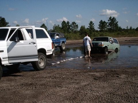 1992 Ford Bronco - Three Ford Broncos are stuck in the mud and water at Holopaw.