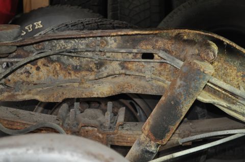 1986 Ford Bronco - Heavily rusted suspension parts and frame components are visible in this close-up shot.