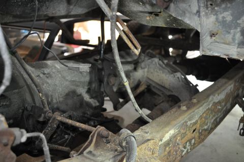 1986 Ford Bronco - Close-up view of the drivetrain and frame of a 1986 Ford Bronco during a teardown.