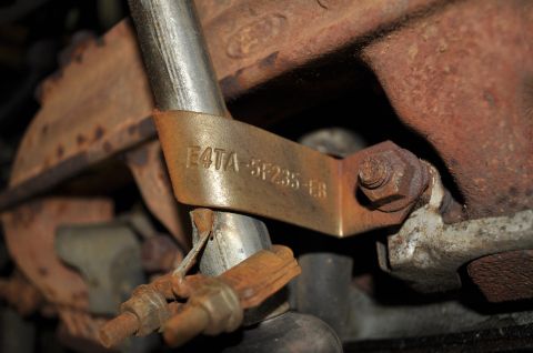 1986 Ford Bronco - A metal tag with part number E4TA-5F235-EB is attached to engine components.