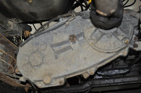 1986 Ford Bronco - Transfer case assembly, likely from a 4x4 vehicle, showing wear and grime.