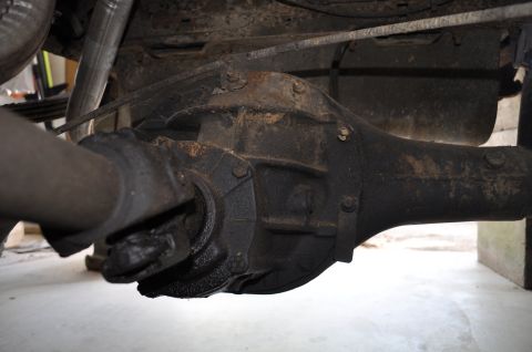 1986 Ford Bronco - Underside view of a vehicle's rear axle assembly, showing signs of wear and rust.