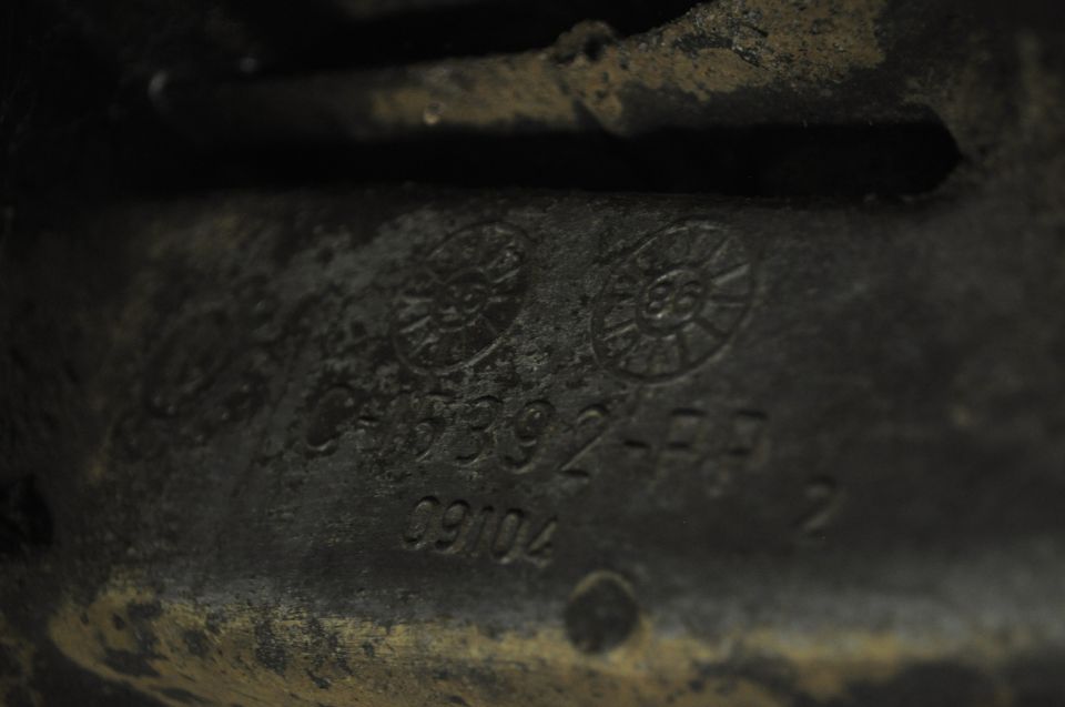 Cast iron part with raised casting number and date code C9104