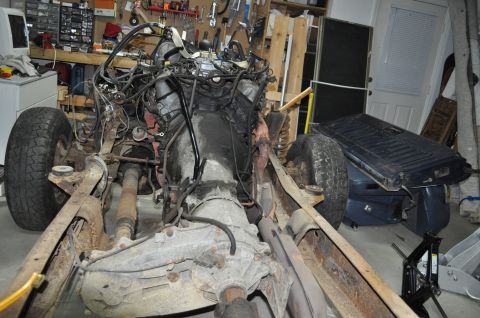 1986 Ford Bronco - Vehicle chassis undergoing teardown, with engine and transmission components visible. The registry claims it is a 1986 Ford Bronco.