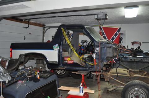 1986 Ford Bronco - This Ford Bronco appears to be from the early 1980s, undergoing extensive repairs in a garage.