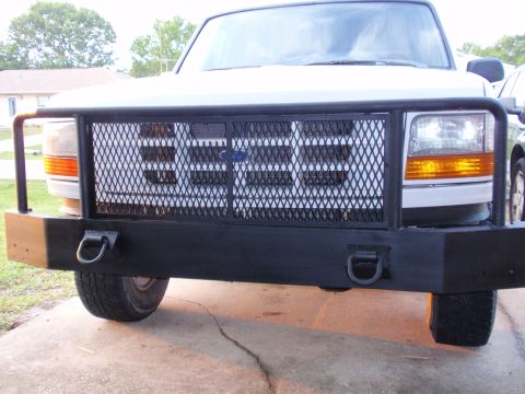 1995 Ford Bronco - Front view of a 1995 Ford Bronco showing its grille and a heavy-duty aftermarket bumper.