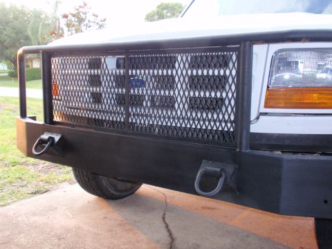 1995 Ford Bronco - The front end of a Ford F-Series truck is shown, a heavy-duty brush guard over the grille.