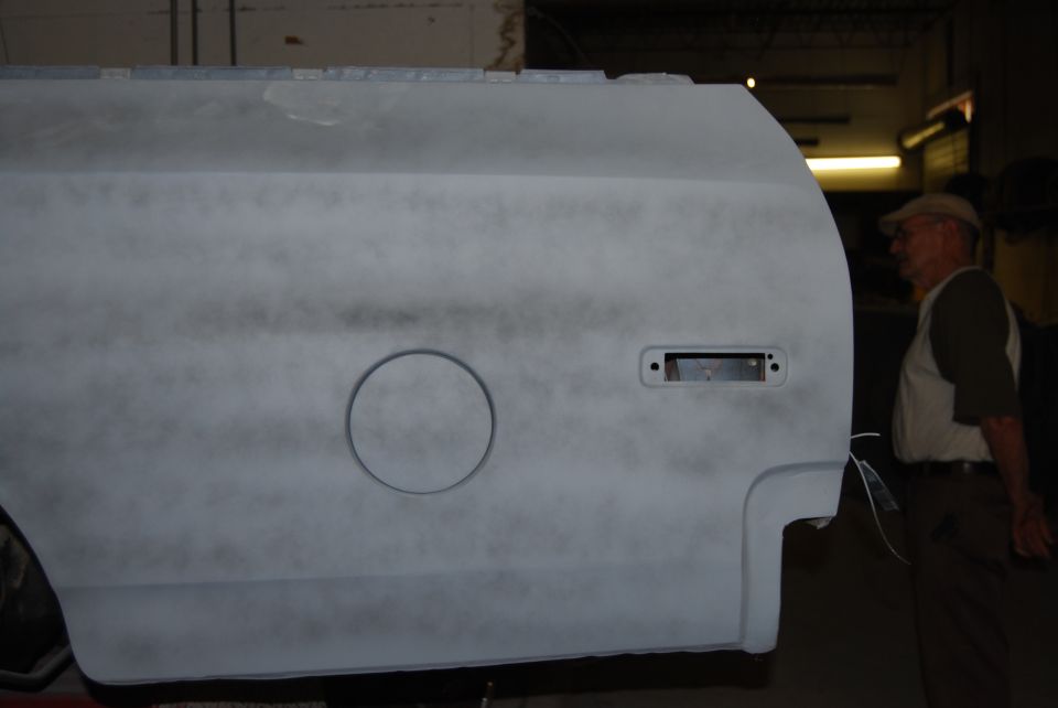 1975 Ford Ranchero side panel, primed, showing fuel door and taillight housing