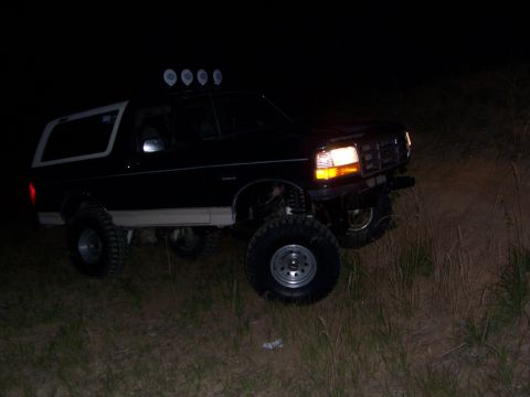 1992 Ford Bronco - This 1992 Ford Bronco is equipped with off-road lights and appears to be navigating rough terrain in the dark.
