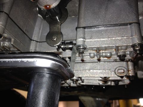 1995 Ford Bronco - Close-up of a vehicle's transmission pan and filter during maintenance.