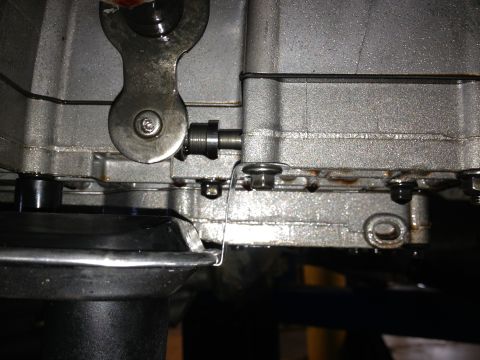1995 Ford Bronco - A close-up view of a transmission's internal linkage and housing, showing mechanical components.