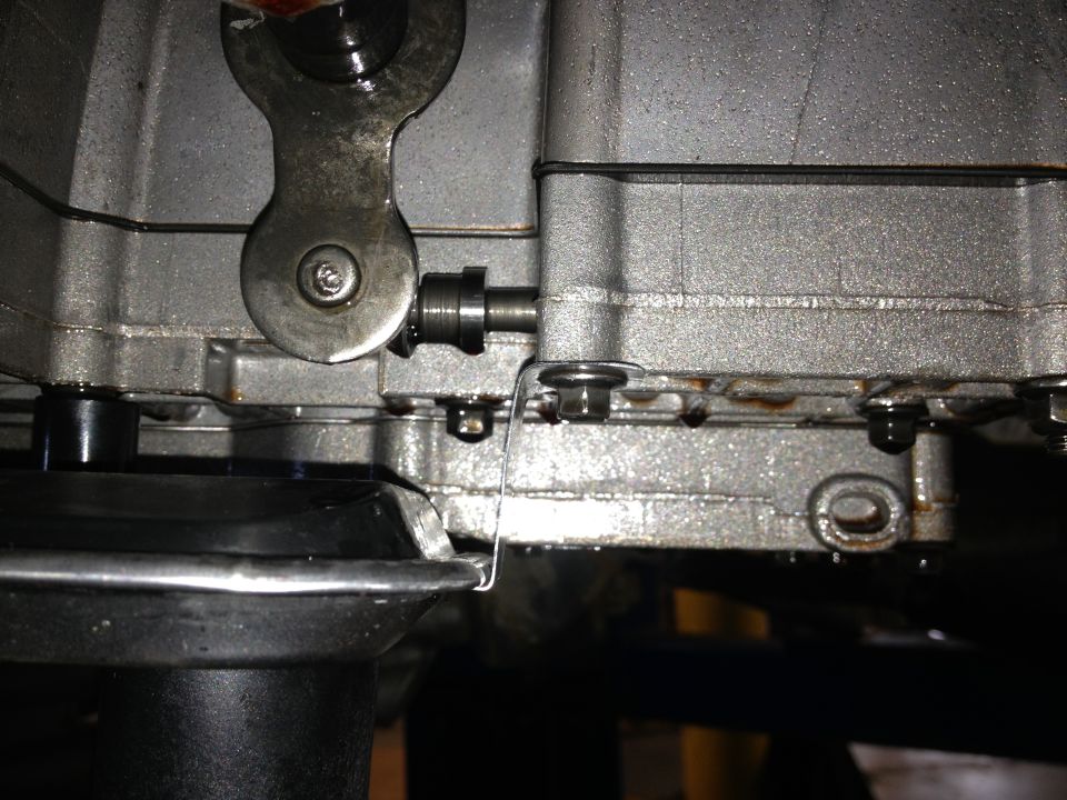 close-up of a metal lever mechanism on a vehicle transmission housing