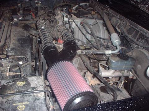 1993 Ford Bronco - The engine bay of a 1993 Ford Bronco shows an aftermarket air intake system.