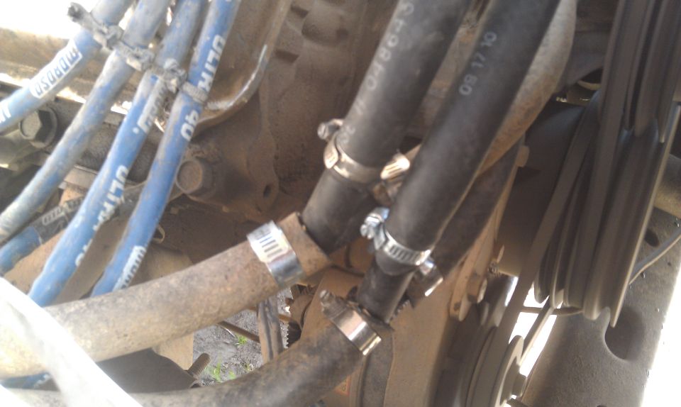 Close-up of engine hoses and blue spark plug wires