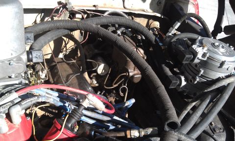 1978 Ford Bronco - Close-up view of a vehicle's engine bay, showing various components and wiring.