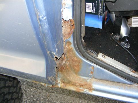 1978 Ford Bronco - Significant rust damage is visible on the door frame and rocker panel of this vehicle.