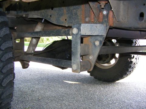 1978 Ford Bronco - Close-up view of the vehicle's undercarriage, focusing on the suspension and drivetrain components.