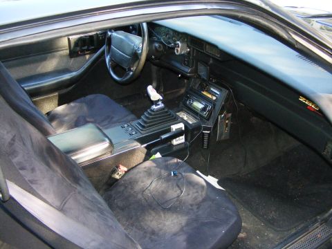 1978 Ford Bronco - Interior of a Z28 Camaro, likely from the 1980s, a manual transmission and aftermarket stereo.