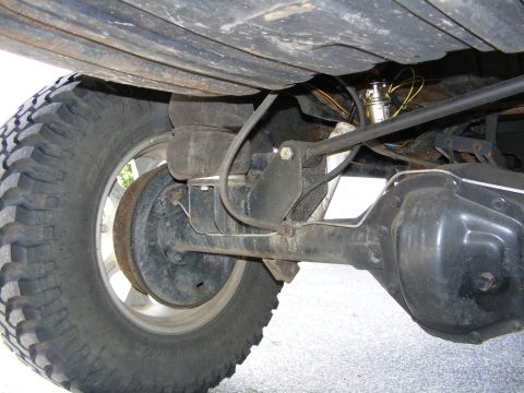 1978 Ford Bronco - Close-up of the rear axle assembly, including the differential and brake components, with visible air suspension.