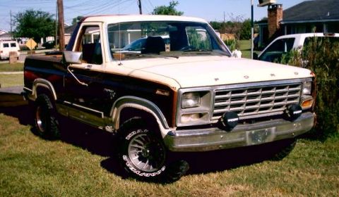 1980 Ford Bronco - This is a 1980s Ford F-Series pickup truck with a two-tone paint scheme and off-road tires.