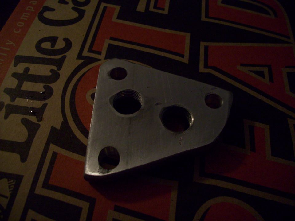 Metal part with three bolt holes and two threaded holes