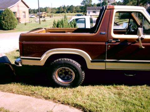 1980 Ford Bronco - This vehicle is a two-tone brown and white Ford Bronco, viewed from the driver's side.