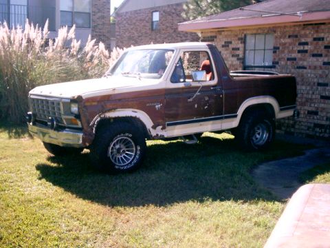 1980 Ford Bronco - Side view of a two-tone 1980 Ford Bronco with brown and cream paint.