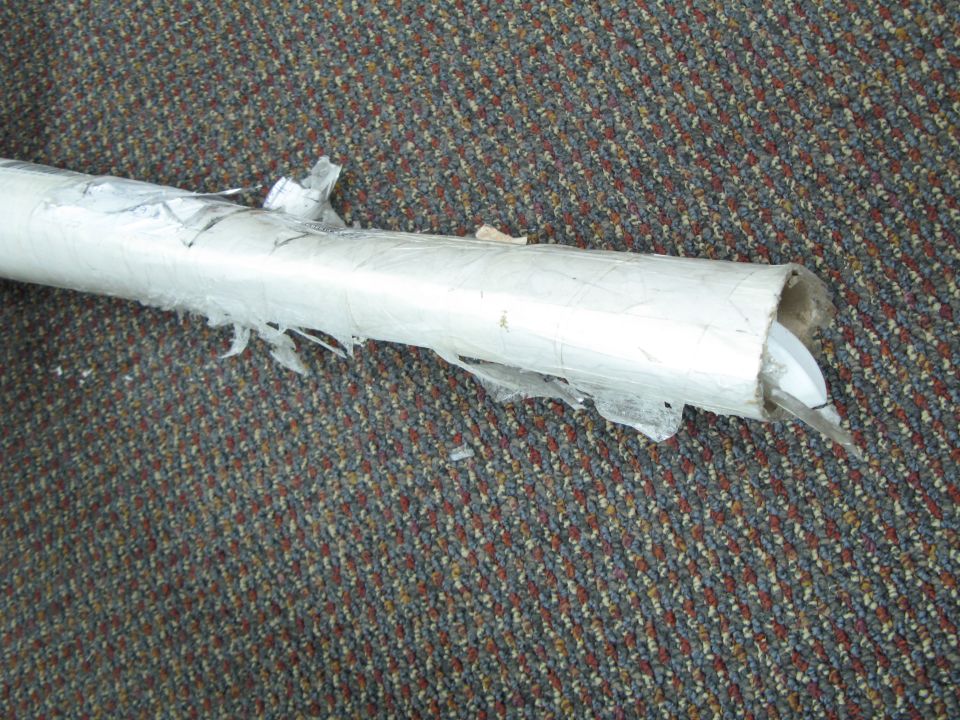 exhaust pipe wrapped in white plastic, on carpet