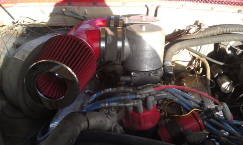 1978 Ford Bronco - Close-up view of an engine bay, highlighting an aftermarket air intake system and various engine components.